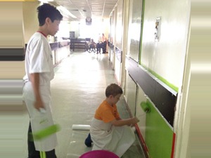 Jerry's son and Dr. Marco's youngest son painting the children's wing of the hospital